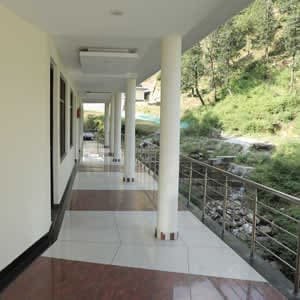 Long open corridor with a mountain view at Hotel Sakshi Uttarkashi, a perfect place to stay in Uttarkashi